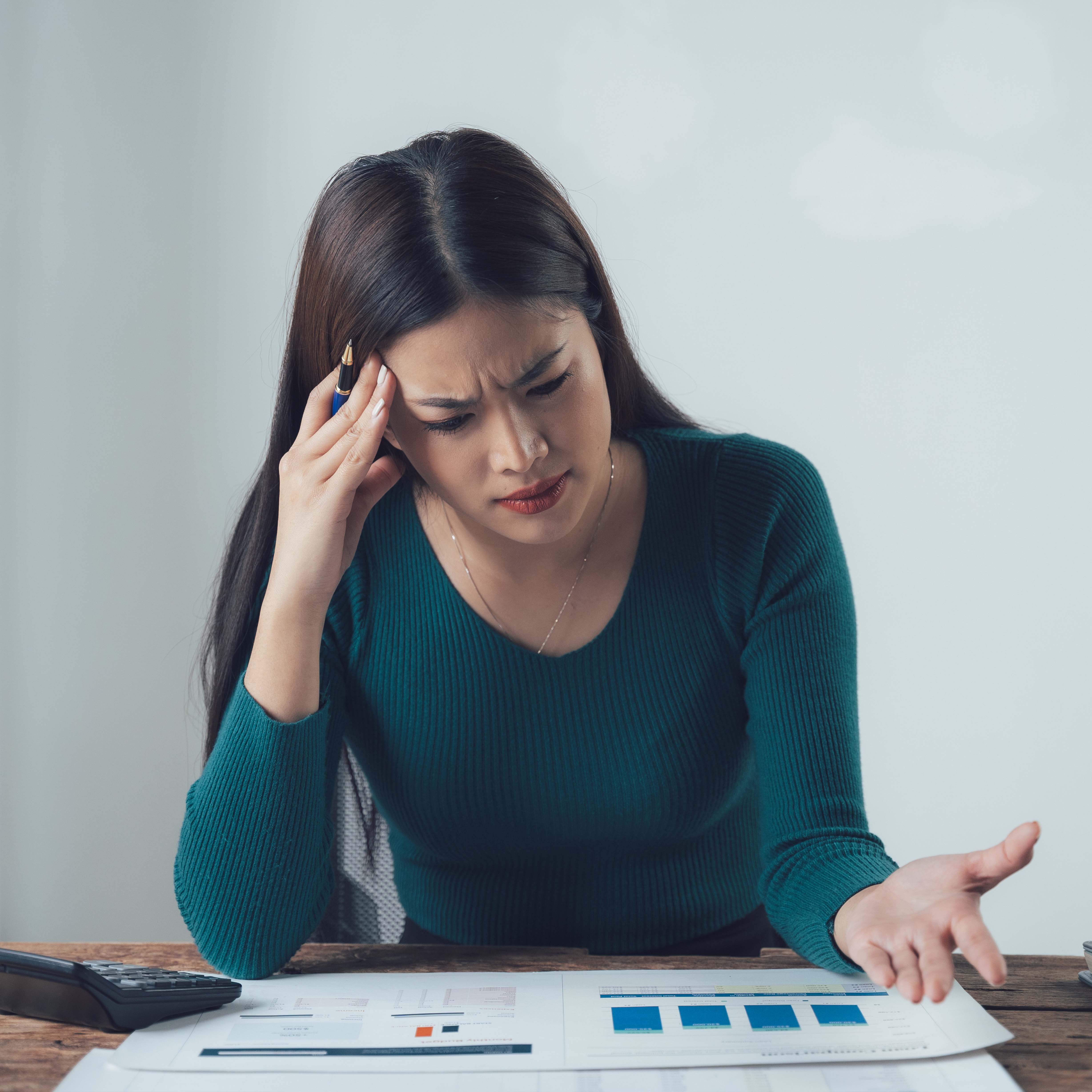 Screaming businessman drowning under a lot of paperwork