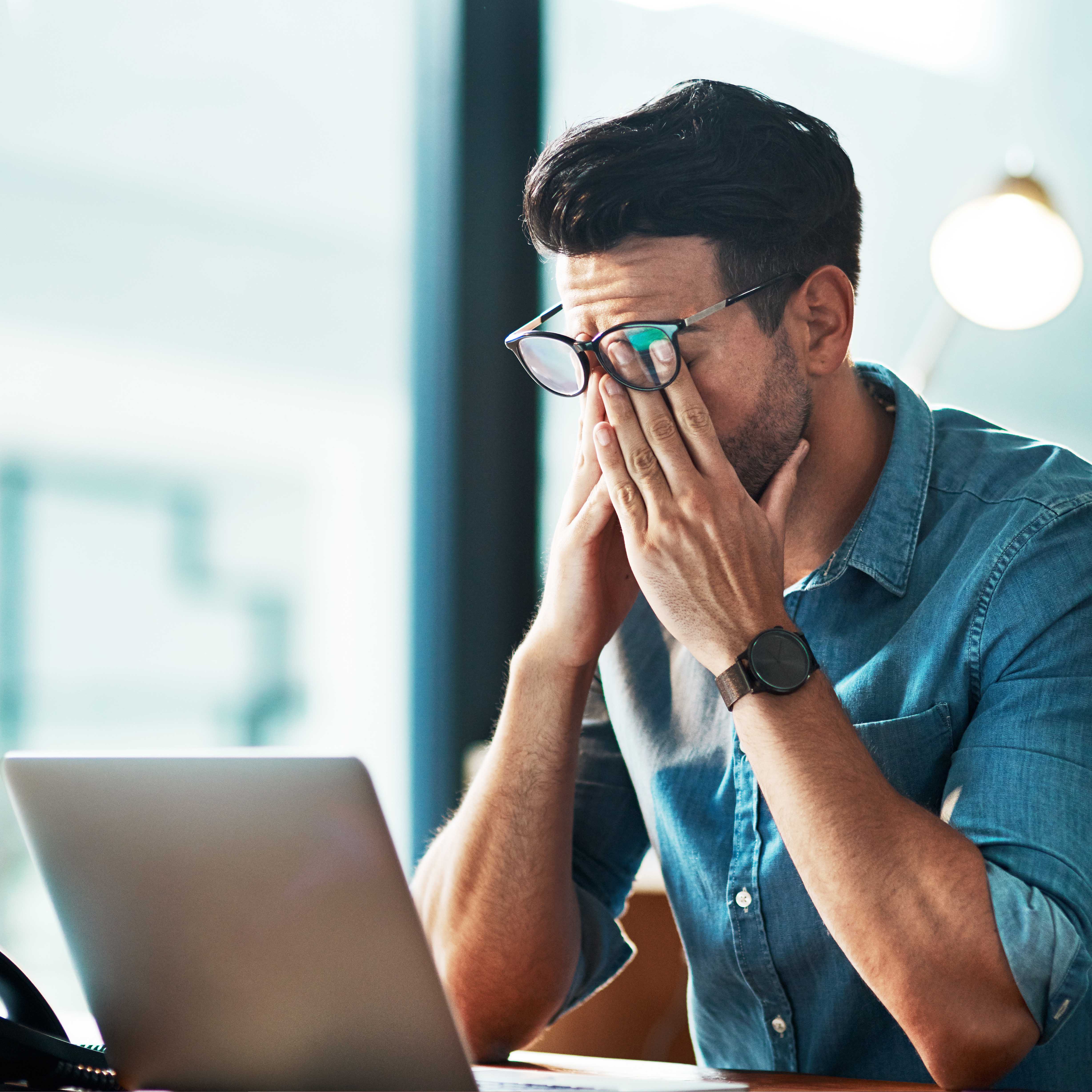 Screaming businessman drowning under a lot of paperwork